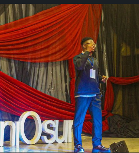 Delivering a keynote speech on stage at TEDx UniOsun